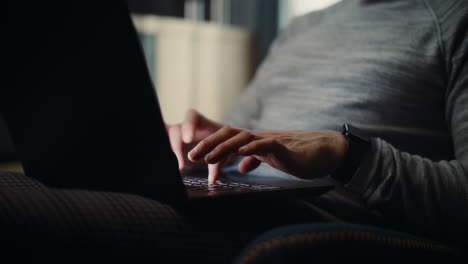 close up of professional focused financial expert working on laptop, monitoring real-time stocks and exchange market charts. successful businessman works in comfortable office of investment bank.