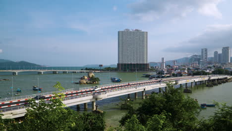 nha trang city skyline with vehicles traffic on tran phu and xom bong bridges over cai river on sunny day, vietnam