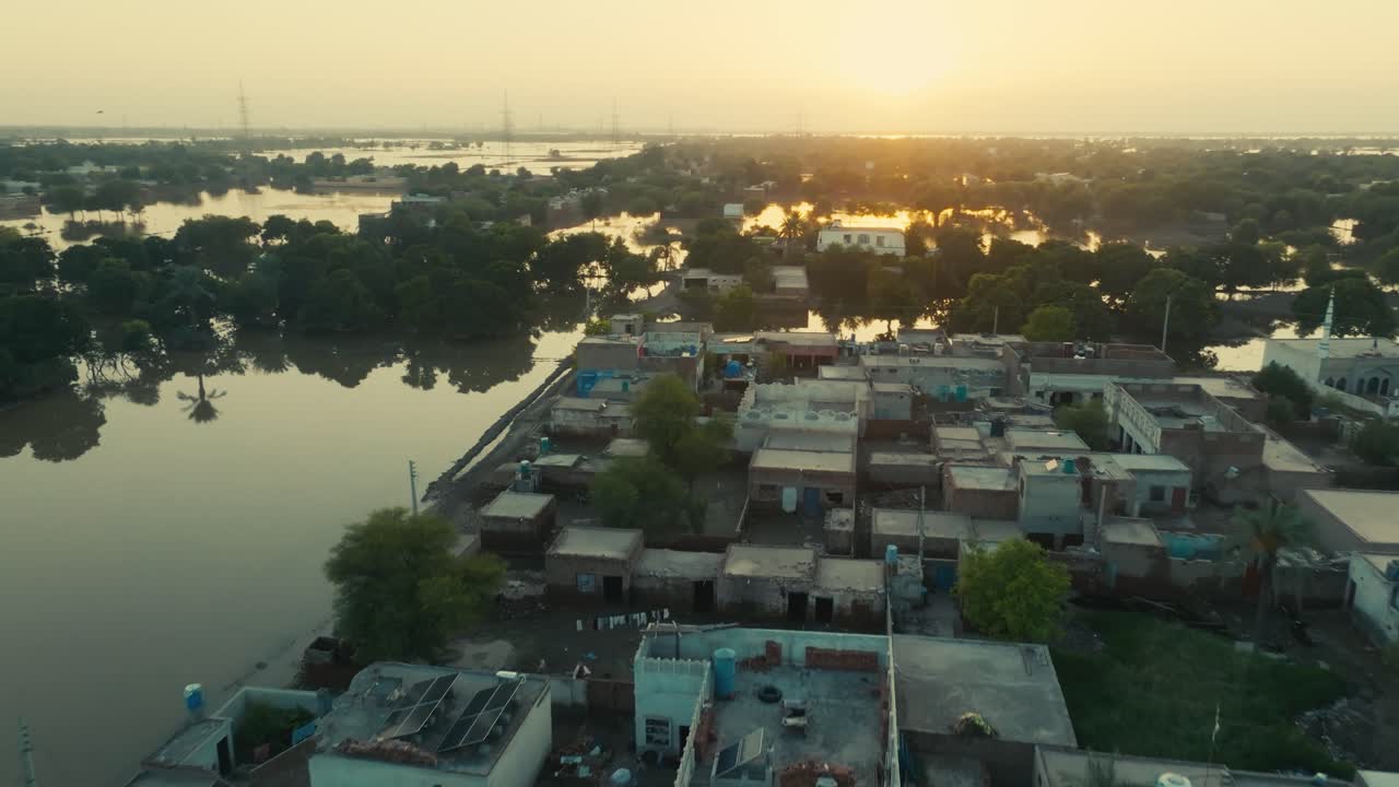 Waterside mosque threatened by rising floodwaters at sunset