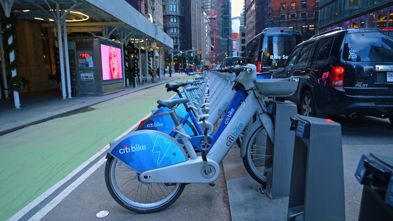 New York, USA, 15 April 2026: Row of Citi Bikes parked at Manhattan docking station. Long line of blue rental bicycles parked at a station on a New York City street near urban buildings.