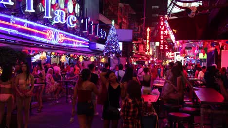 crowded street with neon lights at night