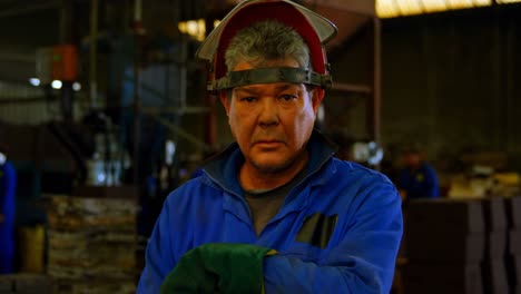 male worker standing in helmet at workshop 4k