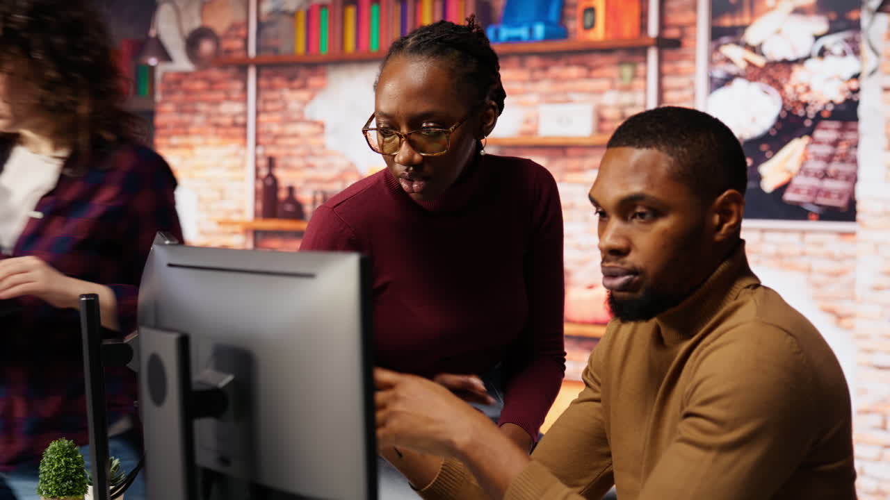 IT coworkers programming in AI startup office