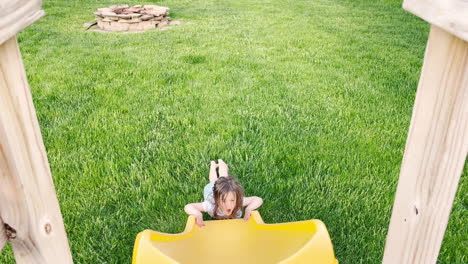 A-little-girl-plays-on-a-sliding-board-in-a-public-park