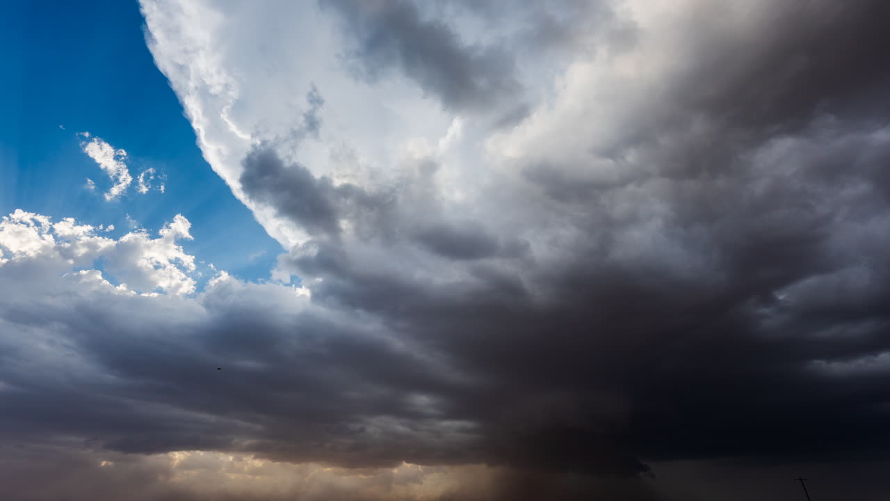 Grå skyer bevæger sig hurtigt hen over himlen og viser et dramatisk vejrskifte udendørs