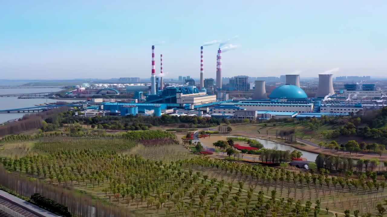 aerial view of seaport large factory oil gas factory with pipes, large storage tanks, oil depot refinery, and a truck transporting fuel and gasoline