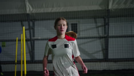 young female soccer players training indoors