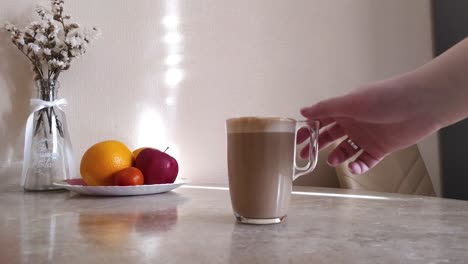 La-Mano-De-La-Mujer-Le-Quita-Una-Taza-De-Café-Caliente-Con-Leche.