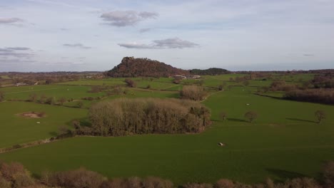 beeston castle sat on beeston crag in the distance - cheshire, england, uk