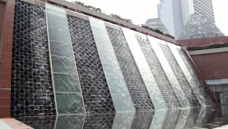 Handheld-shot-of-a-beautiful-water-feature-at-the-Millenia-Tower-in-Singapore