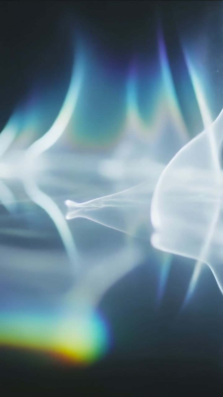 Vertical video: Advancing frames, ribbons rising over band on set, right form entering, prism flare