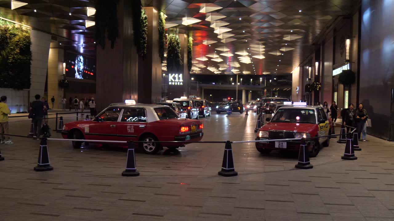 Hong Kong Taxis and K11 MUSEA Building Entrance at Night