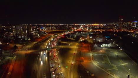 aerial view of cars driving down the interstate at night in denver, colorado