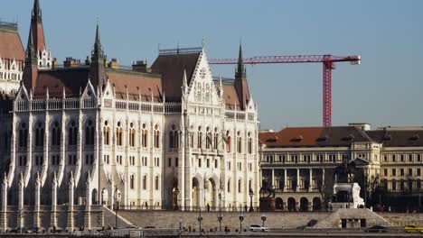 Budapest-city-center-view-with-Parliament-building-and-Danube-river-on-a-sunny-day,-gothic-architecture,-medium-distant-shot