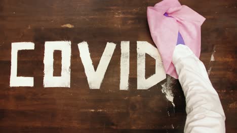 time lapse: covid-19 letters sprayed and removed with pink wipe