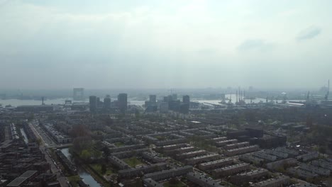 Flying-Over-NDSM-Neighborhood-On-A-Misty-Day-In-Amsterdam,-Netherlands