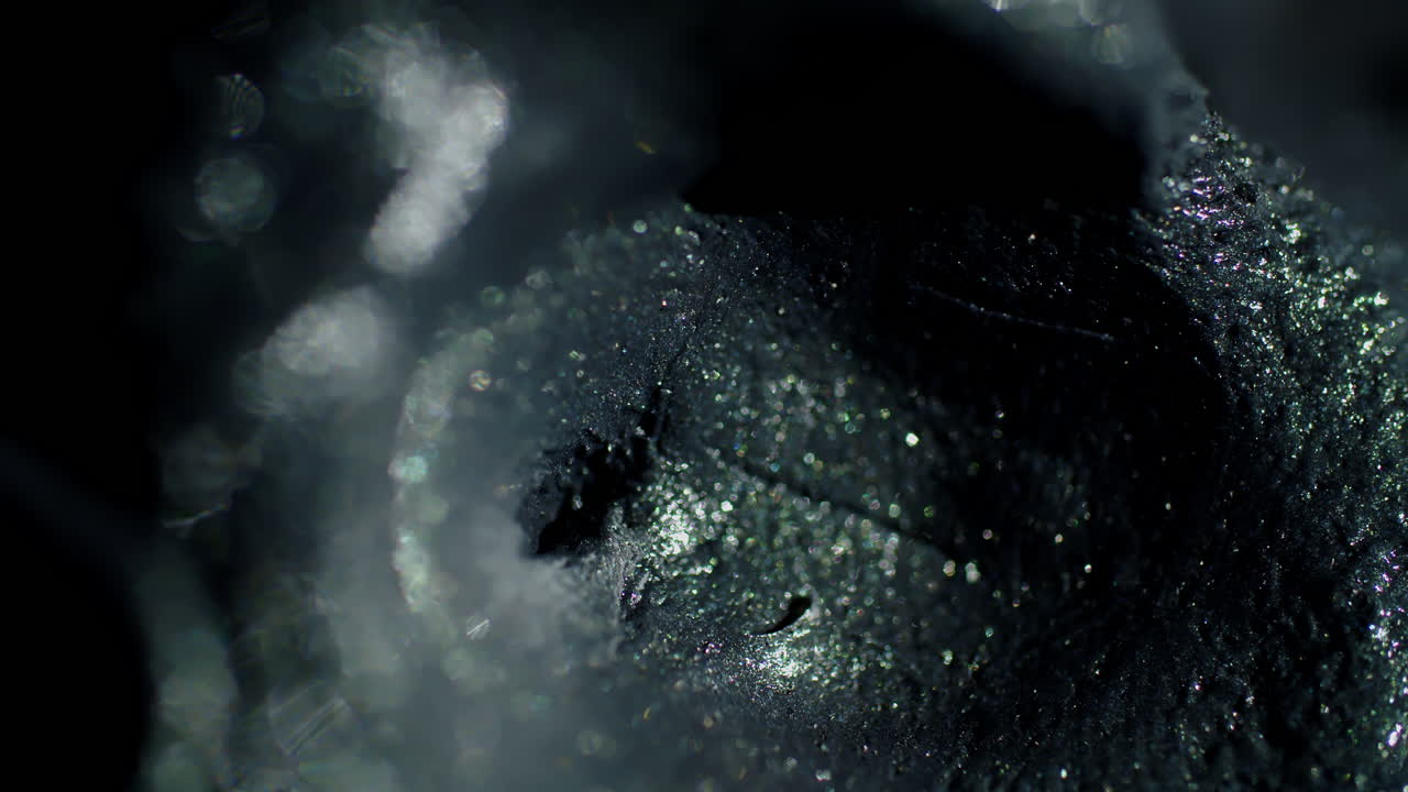 Gray abstract shape as it very slowly shifts in and out of focus while the bokeh texture evolves and changes