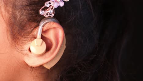 a young woman wearing a hearing aid