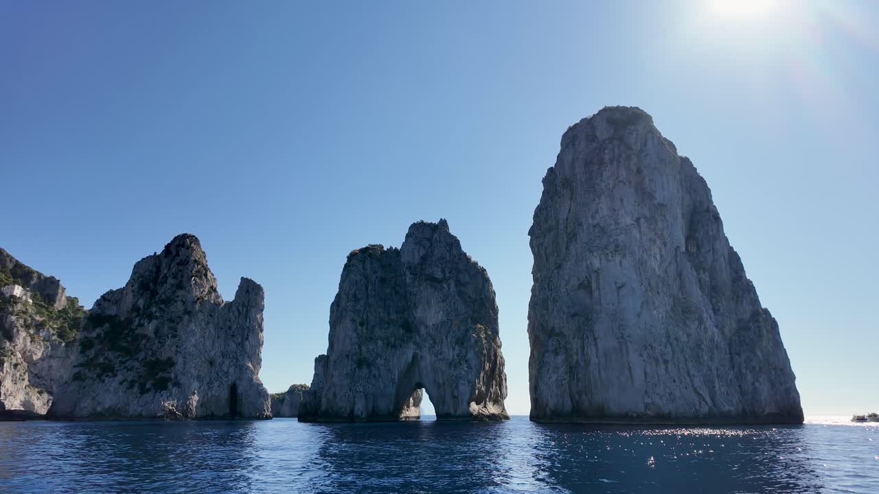 Faraglioni Rocks At Capri In Naples Italy. Beach Landscape. Tourism Landmark. Faraglioni Rocks At Capri In Naples Italy. Bay Of Naples Skyline. Geological Formation. Paradisiac Capri Island.