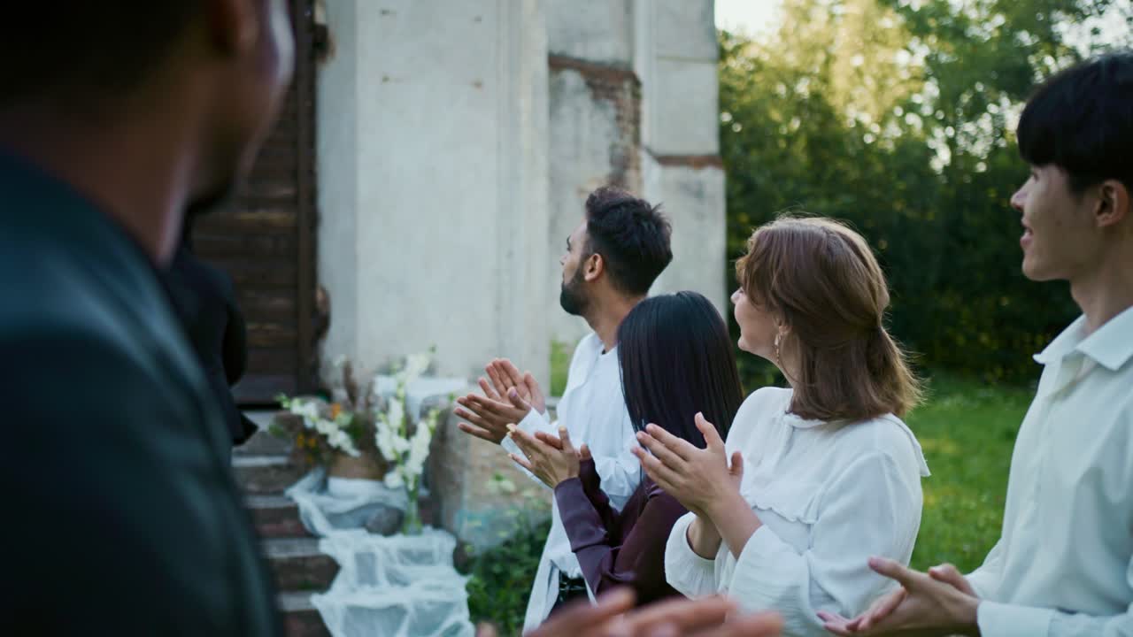 A group of people clapping at a wedding