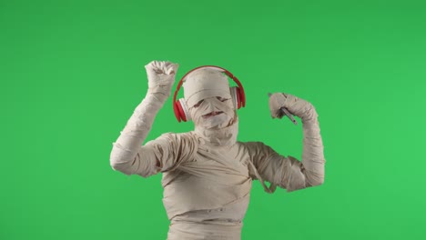 green screen isolated chroma key video capturing a mummy dancing and singing actively into the - green screen isolated chroma key video capturing a mummy dancing and singing actively into the microphone. haloween holidays. mock up, workspace for your promotion clip or advertisement