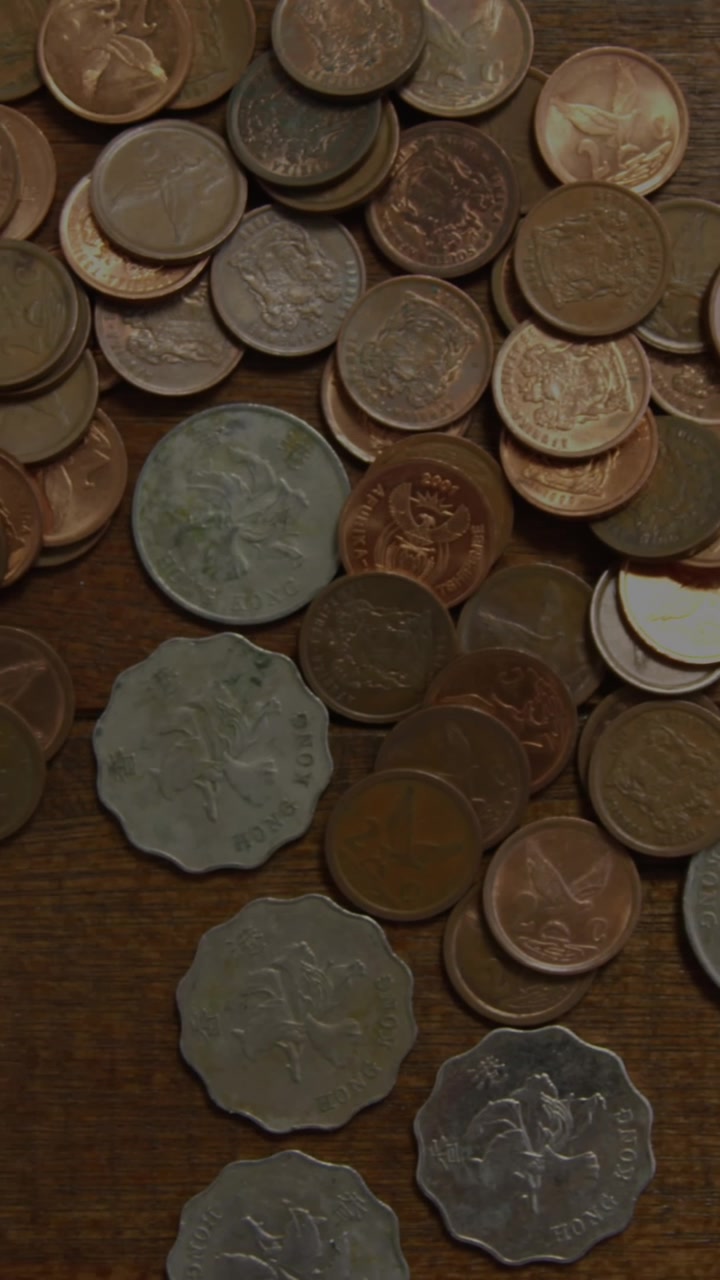 Animation of stars over coins on wooden background