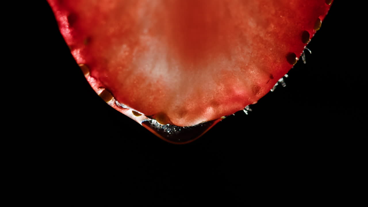 Close-up of a strawberry slice with a water droplet