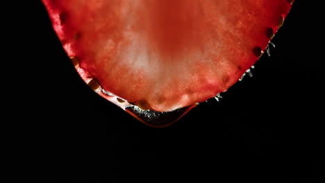 close-up of a strawberry slice with a water droplet