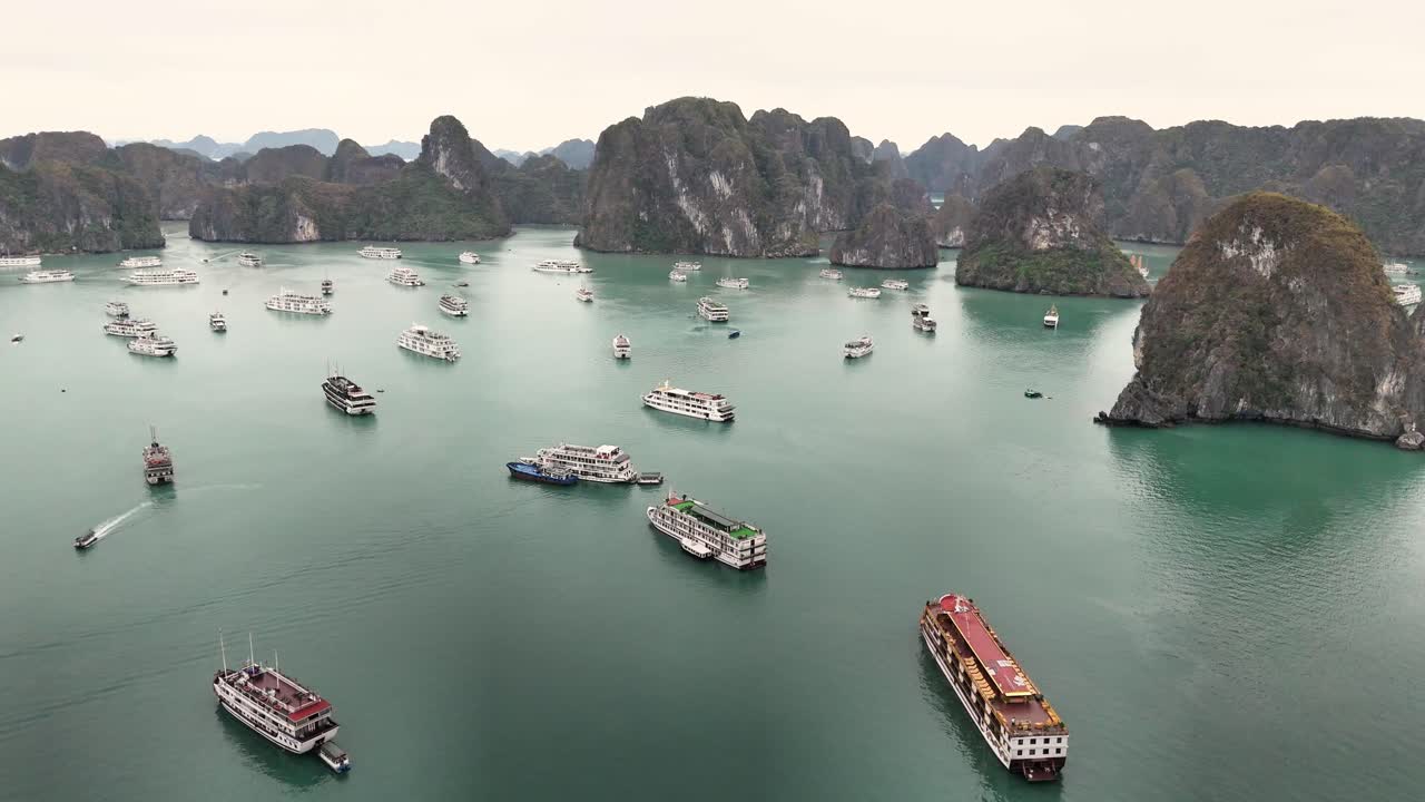 Turquoise waters surround towering limestone islands in Ha Long Bay, Vietnam