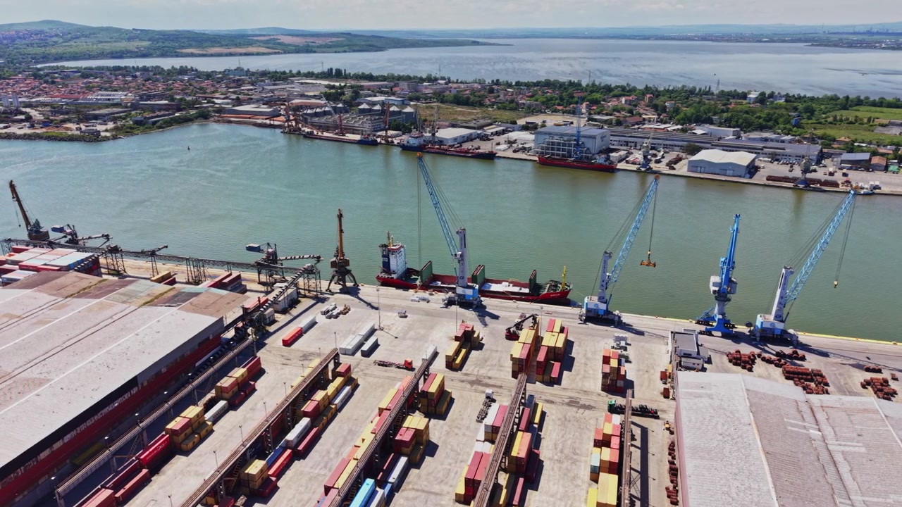 Shipping activities at a busy dock along a river in a port area