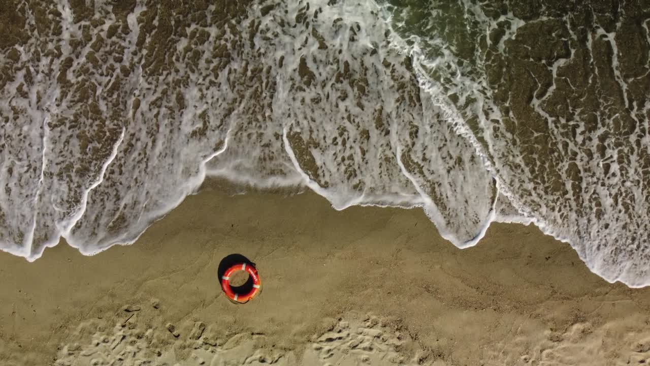 Top view of lifebuoy in the sea shore. Life ring floating in a sea.
