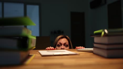 woman peeking over desk