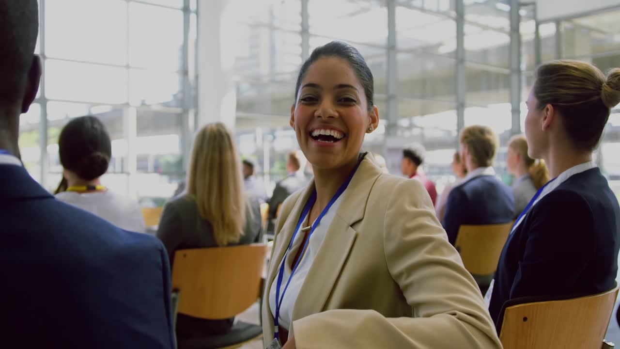 Businesswoman looking at camera during seminar 4k