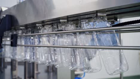 empty plastic bottles on conveyor line. bottle production line. plastic bottles for liquid products on conveyor belt in modern milk plant.