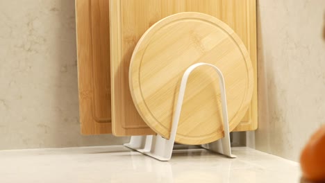 wooden cutting boards in a white rack