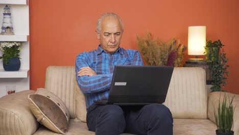 Old-man-watching-movie-on-laptop-with-happy-expression.