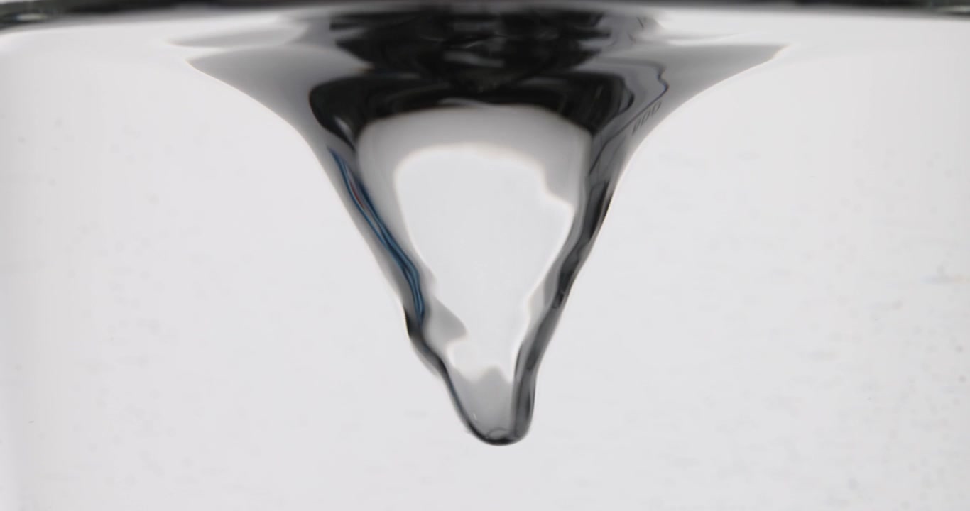 Small transparent liquid swirl rotation view from underwater