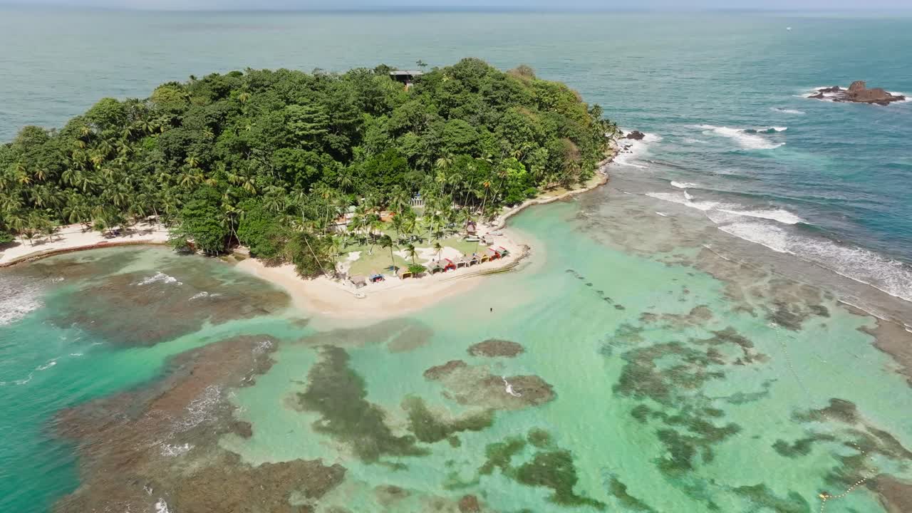 drone footage flying away from an island in the caribbean