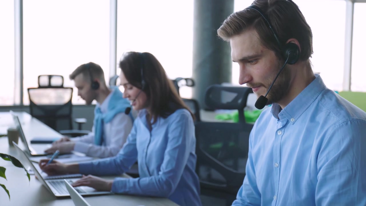 Customer Service Agents Working in a Modern Call Center Office