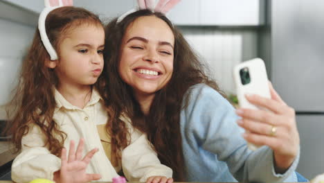 mother and daughter taking a selfie with bunny ears