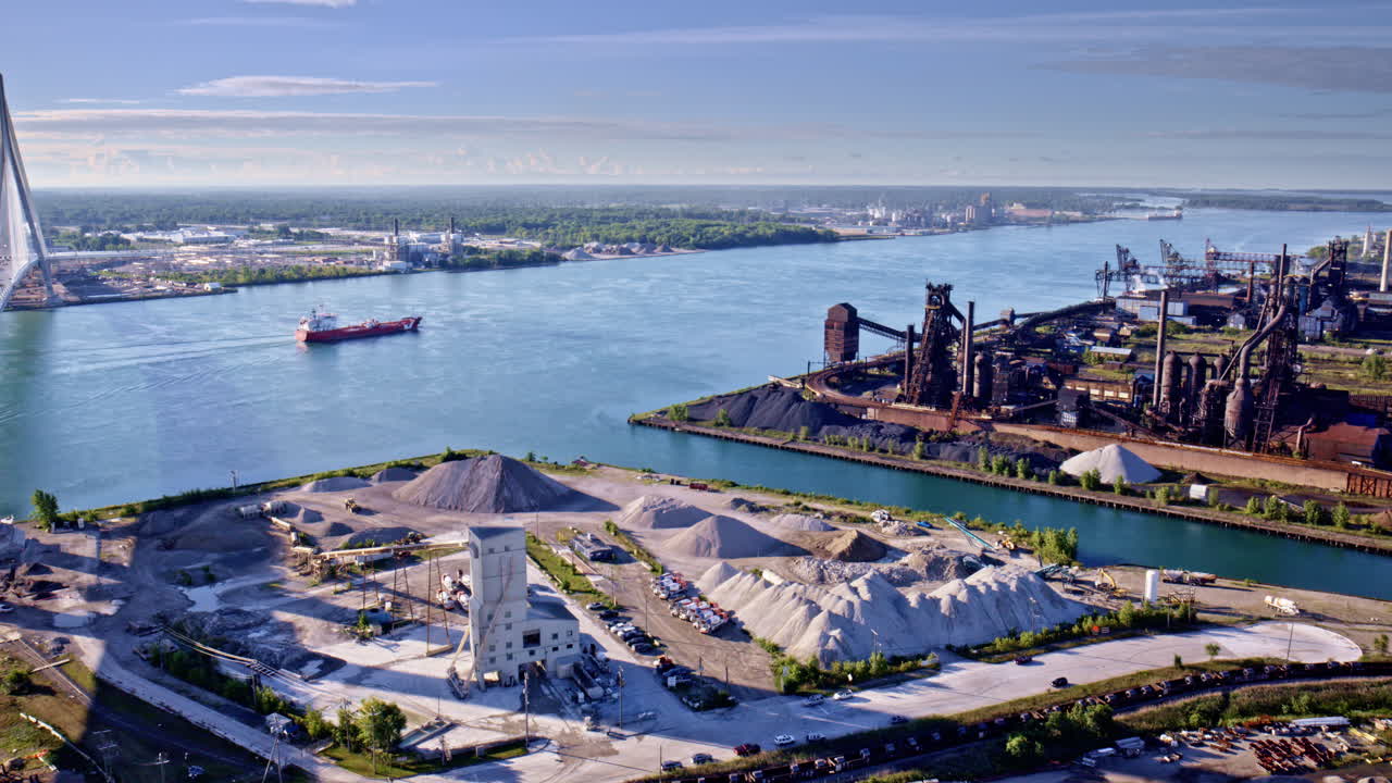 Aerial drone shot smoothly flying around the bridge between Canadian and U.S. shores