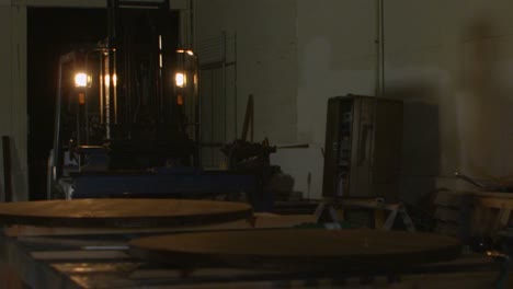 a forklift maneuvers in a woodworking shop