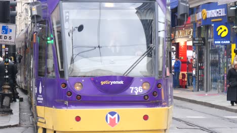 people walking by a tram in istanbul, turkey