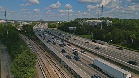 drone shot showing busy multi-lane highway in atlanta city during sunny sky