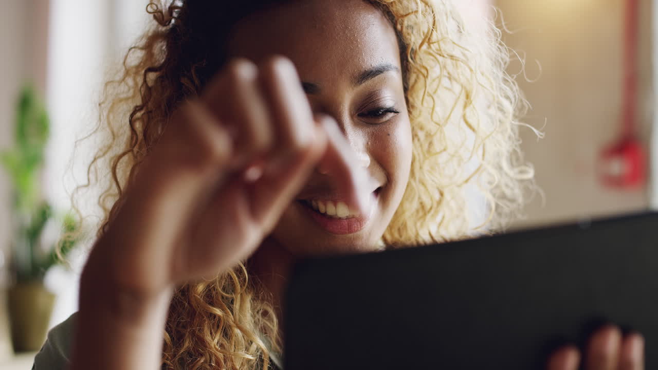 Mixed race teenager using ipad tablet computer touchscreen in cafe