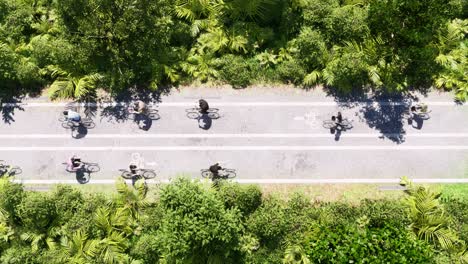 Bicycles-with-bicyclists-moving-on-a-bicycle-road