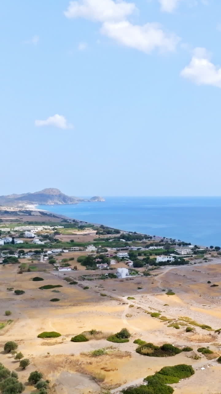 Vertical drone shot rising in front of the east coast of Rhodes, sunny Greece