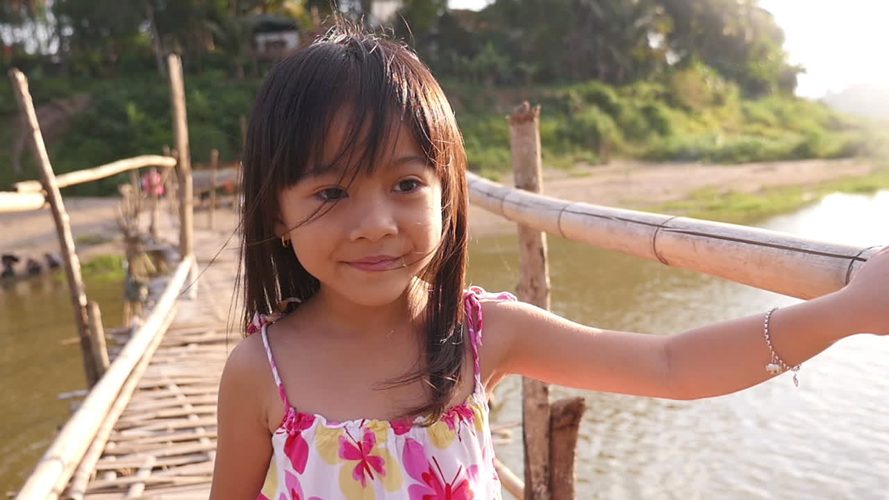 Smiling Girl on a Bamboo Bridge