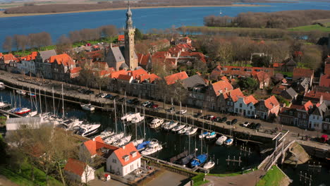 aerial: the historical town of veere with an old harbour and churches, on a spring day