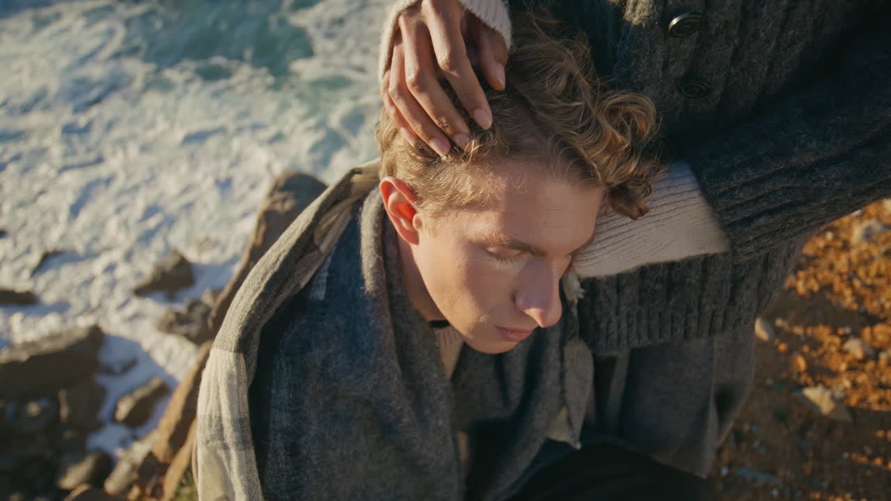 Closed eyes guy leaning woman sunshine sea background closeup. Romantic couple